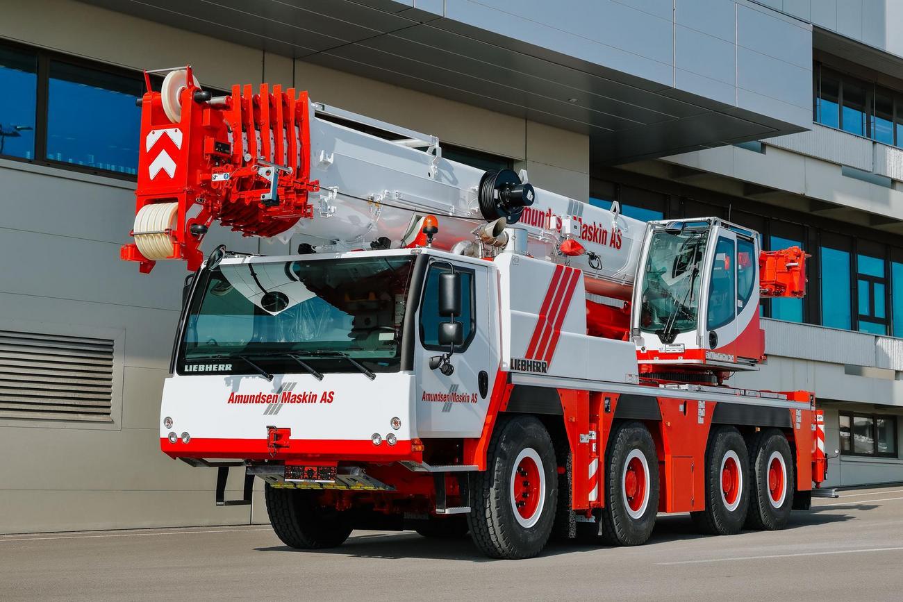 Foto av en stor hvit mobilkran med logoen til Amundsen Maskin p&aring;